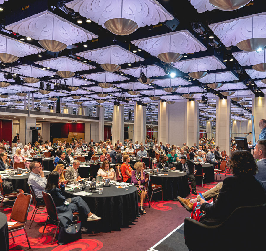 Delegates in conversation at a workplace wellbeing conference